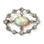 A Belle Époque opal and diamond brooch, c.1905-1915,with a single oval cut cabochon opal, rub set in