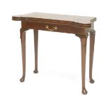 A George II-style mahogany fold-over tea table,the top with lobed corners, on lappet carved legs