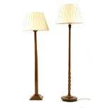 Two 20th century walnut standard lamps, the largest 182cm tall