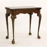 A George II style mahogany fold over card table, with cabriole legs on claw and ball feet, 76cm