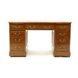 An Edwardian mahogany pedestal desk, the base with panelled sides, on brass castors, 138cm wide,