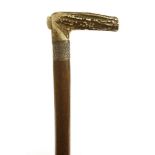 A match walking cane, London 1898, with a silver ferrule and a bone handle, having an aperture for