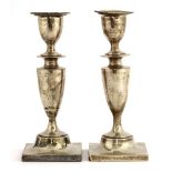 A pair of Edwardian silver candlesticks, London 1903, by Charles Boyton (II), the plain vase-