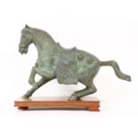 A bronze figure of a horse in the renaissance style, on a wooden base, 43cm long and 29cm high