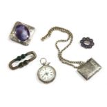 A collection of silver jewellery to include a silver Ruskin style brooch, set with purple and red