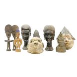 A collection of African hardwood tribal items, to include two masks, and a Benin style bronze head