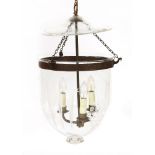 A modern ceiling-mounted clear glass hall/storm light, with etched decoration, pressed metal mounts,