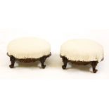 A pair of Victorian carved walnut foot stools, each with calico covering and on scroll feet, 32cm
