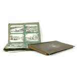 An Edwardian postcard album, comprising seaside and street scenes, also including an envelope with