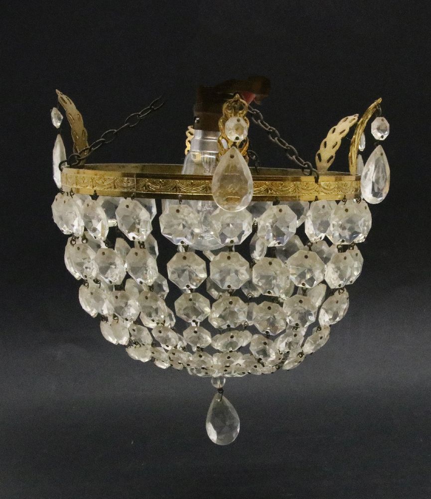 A ceiling light, 20th century, with prismatic drops hanging from a gilt metal border,20.5cm