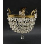 A ceiling light, 20th century, with prismatic drops hanging from a gilt metal border,20.5cm