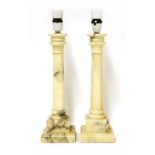 A pair of alabaster table lamps, 20th century, on stepped square bases, 41cm high overall (29)