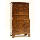 A George III mahogany secretaire chest on chest in two sections, the upper fitted two short above