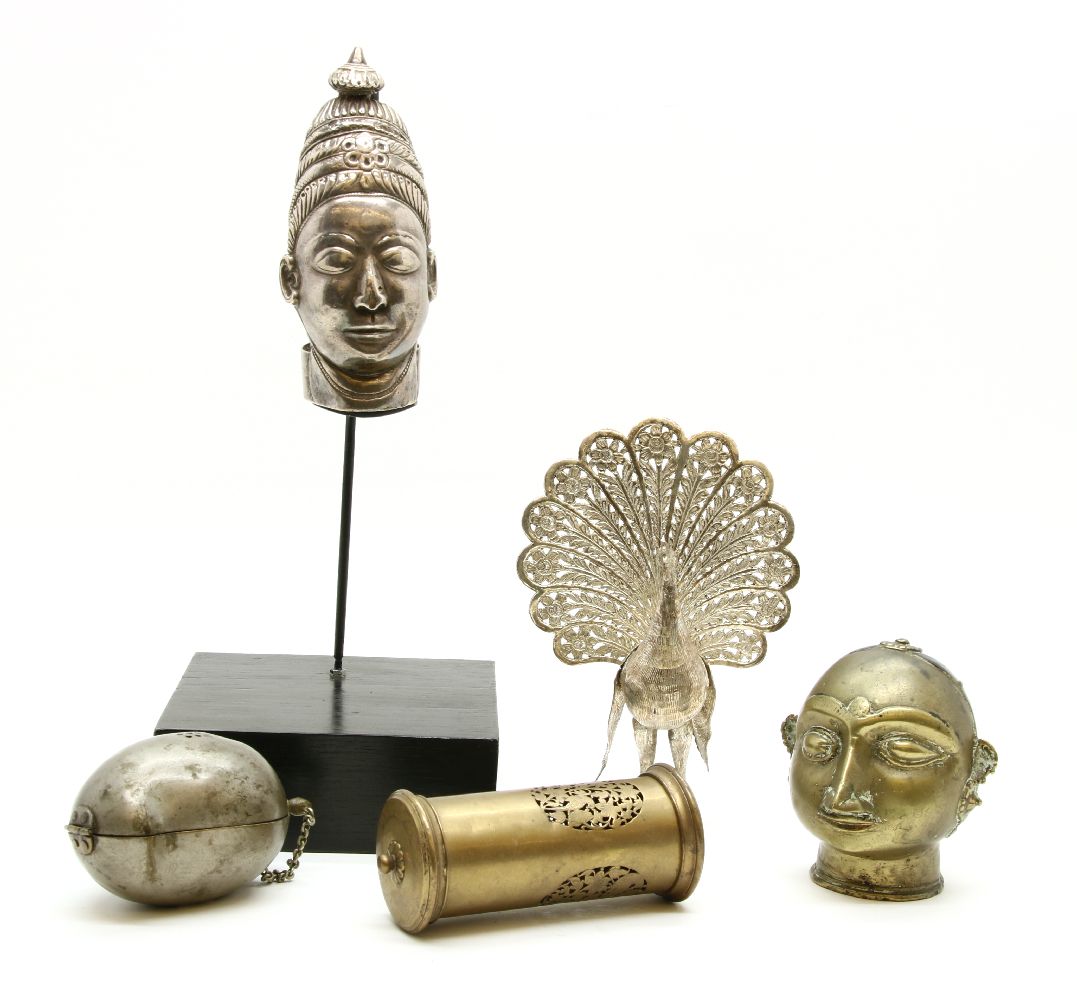 A white metal bust of an Indian deity, 15cm high, together with a pierced brass cricket cage and