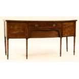 A Regency mahogany bow fronted sideboard, having central frieze drawer flanked by cupboards on