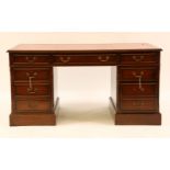 A reproduction mahogany nine drawer twin pedestal desk, with a red leather inset, 154cm wide, 92cm