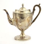 An Old Sheffield plate coffee pot, c. 1790, of oval form, decorated with a band of scrolling foliage