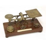 A set of Samson Mordan brass postal scales, with seven associated weights and an applied plaque, '