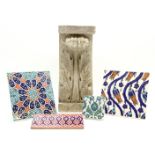 A carved stone corbel with acanthus detail, together with a collection of Persian tiles