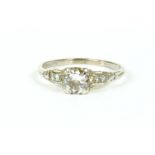 A single stone brilliant cut diamond ring, with eight cut diamond set shoulders to a plain