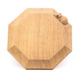 A Robert 'Mouseman' Thompson oak teapot stand, of octagonal form with carved mouse signature,