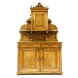 A walnut buffet, with a raised top, over two drawers and cupboard below, 127cm wide, 64cm deep,