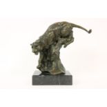 A contemporary bronze of a leopard on a tree stump, 30cm high