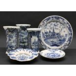 An 18th century Dutch Delft charger, depicting a scene of fishing boats in a harbour, surrounded