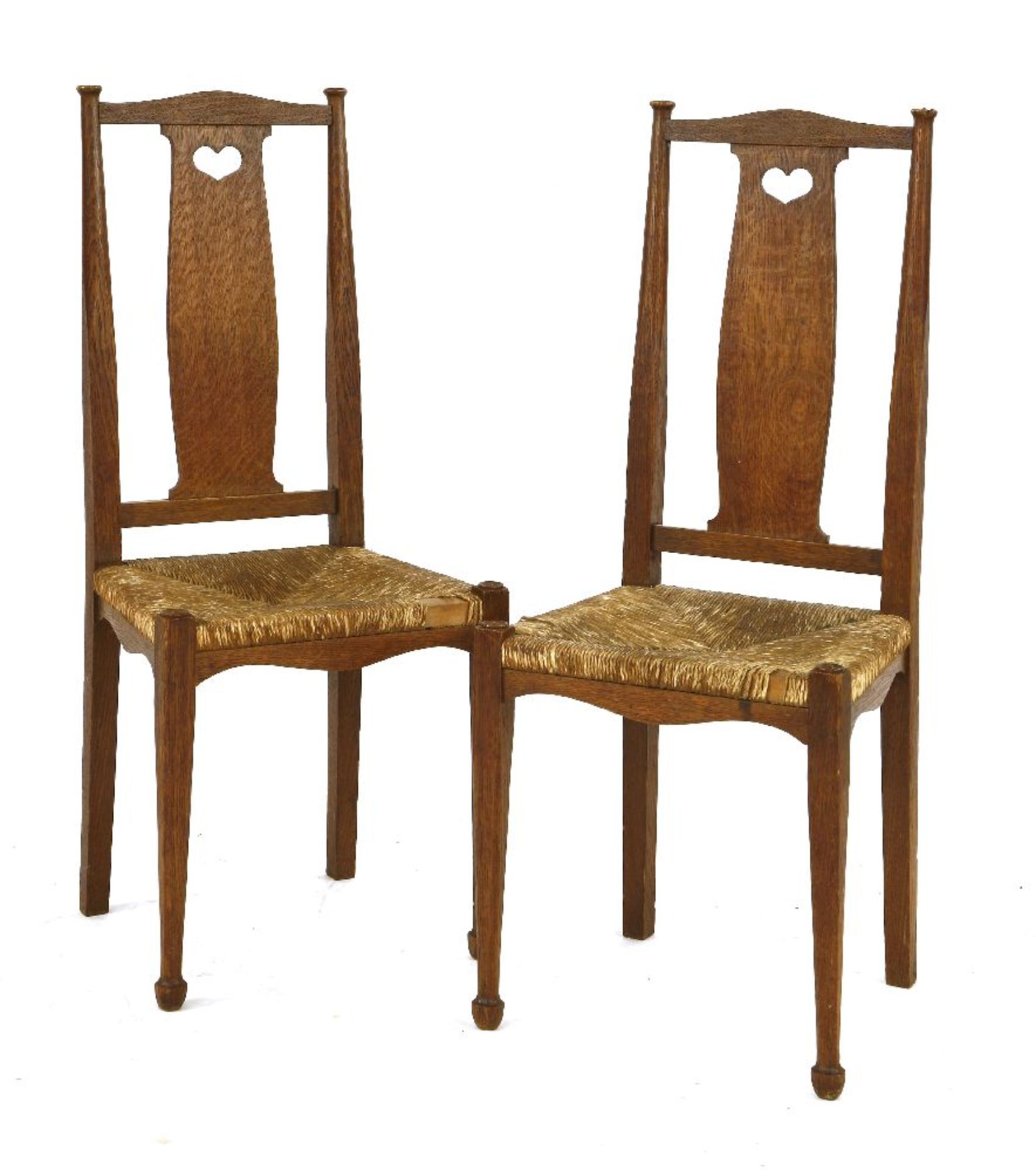 A pair of ‘Fine Feathers’ oak bedroom chairs, designed by Ambrose Heal for Heal & Son, each with