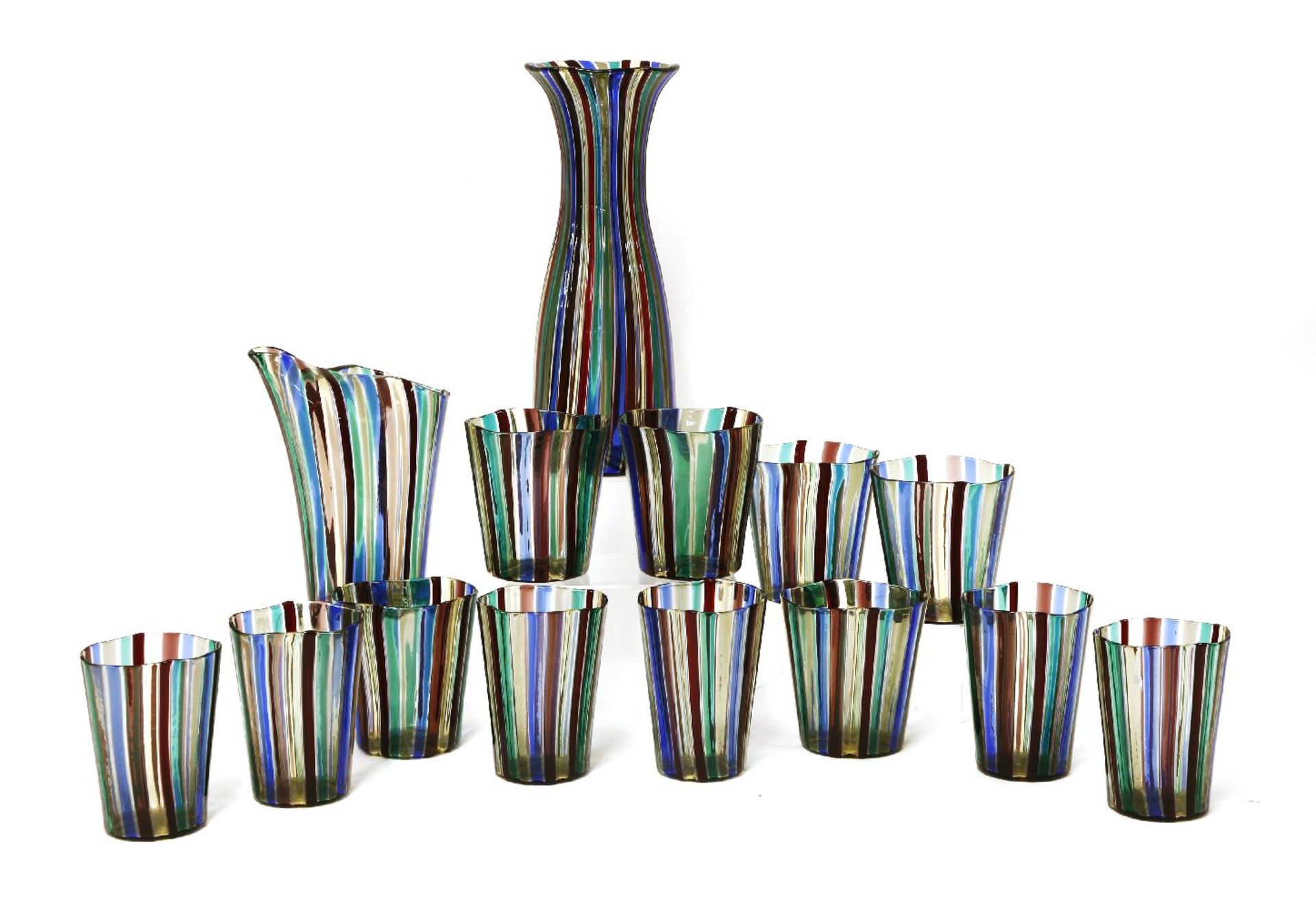 A set of twelve 'A Canne' beakers,designed by Gio Ponti for Venini,a jug,18cm high, anda carafe,26cm