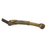 A TILLER ARM,early 19th century, a wooden tiller arm, carved with a human arm holding a ball