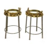 A PAIR OF SHIP'S PORTHOLE OCCASIONAL TABLES,raised on tubular metal stands,77cm high