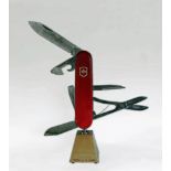 A SWISS ARMY KNIFE,late 20th century, a motorised moving display model of a Swiss army knife by