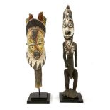 AN ANCESTOR FIGURE,mid-20th century, a tribal carved, wooden and painted ancestor figure on stand,