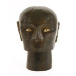 A TORAJA TAU TAU HEAD,1950s, a carved wood and bone, tribal Toraja Tau Tau head from South Sulawesi,