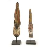 ANCESTOR FIGURES,mid-20th century, a tribal carved wooden ancestor figure on a stand,together with a