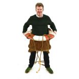 A BREECHES BUOY,the cork ring with ropework and canvas seat