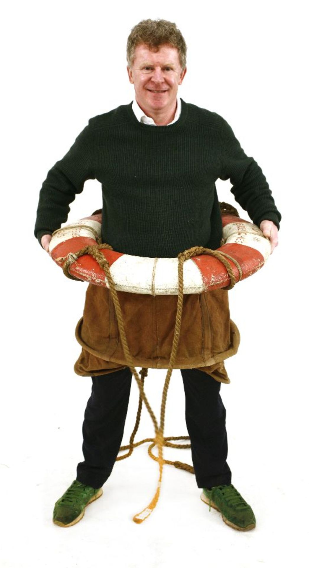 A BREECHES BUOY,the cork ring with ropework and canvas seat