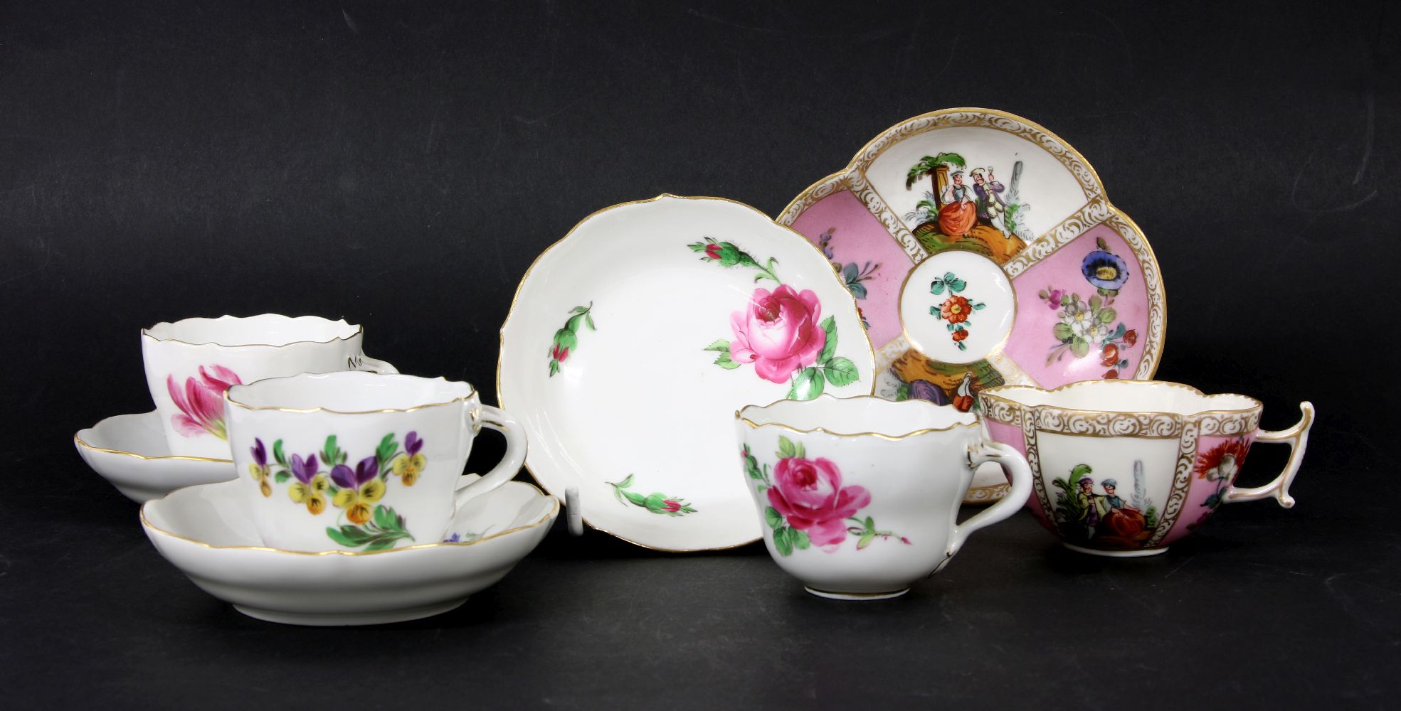 Three Meissen cups and saucers, decorated with floral sprays, together with a Dresden cup and saucer