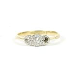 A gold three stone illusion set diamond ring, marked 18ct and Plat (one stone deficient), 1.89g