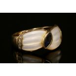 A 9ct gold sapphire, mother-of-pearl and diamond ring,with a marquise cut sapphire rub set to the