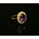 A 9ct gold oval mixed cut amethyst and seed pearl cluster ring, size N, 4.13g