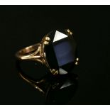 A gold single stone oval cut andalusite ring, double claw set to trefoil shoulders and a plain