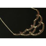 A French silver gilt garnet set swag centrepiece necklace, with graduated rose cut garnets, marked