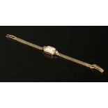A ladies 9ct gold Tudor mechanical bracelet watch, movement signed Tudor, silver dial, Arabic