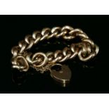 A 9ct gold hollow textured and polished curb link bracelet with padlock, marked 9ct (tested as
