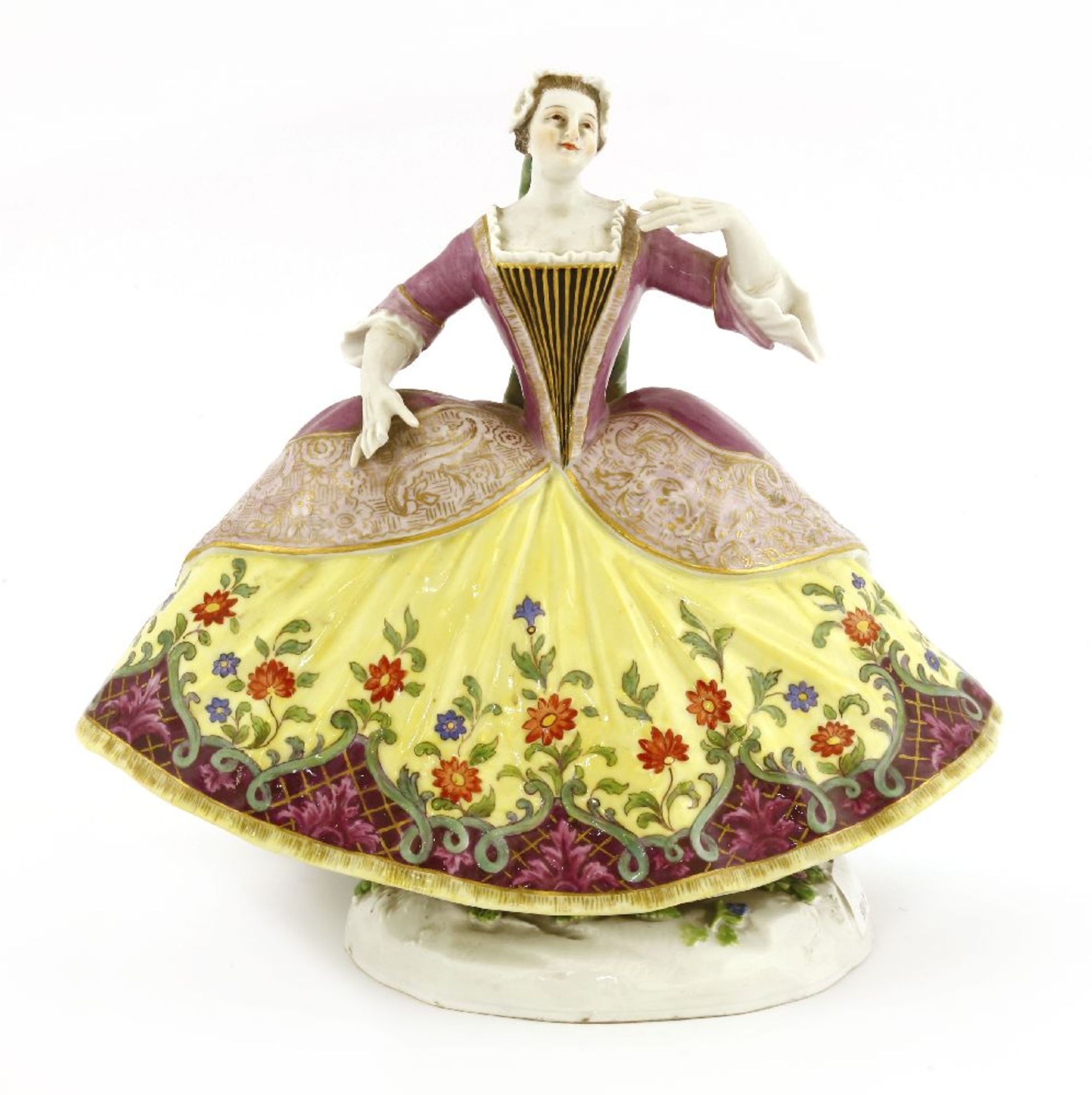 A Meissen porcelain figure of Kitty Clive, wearing a large billowing dress, purple with scrolling