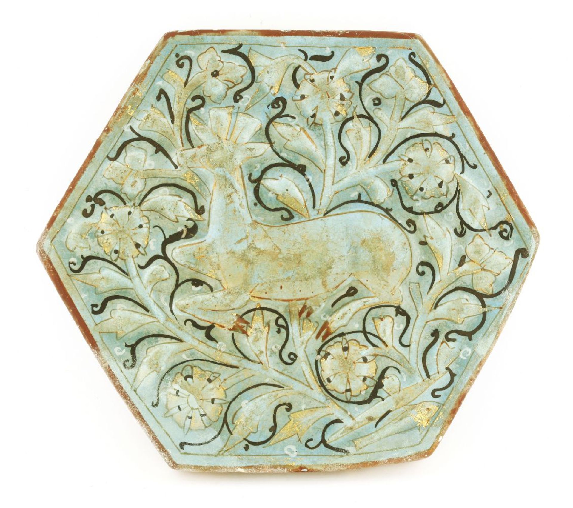 A rare moulded pottery tile,early 14th century, Kashan, of hexagonal form, turquoise-glazed and