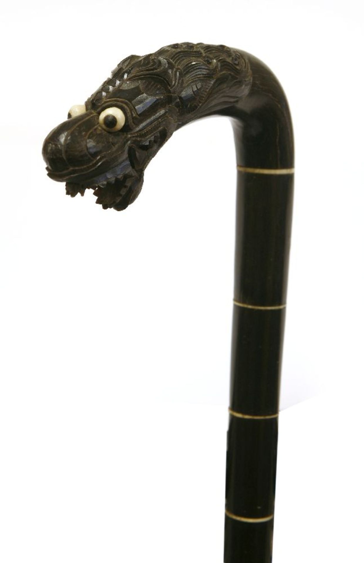 A South East Asian horn walking stick,c.1880, the terminal carved with a dragon,82cm long