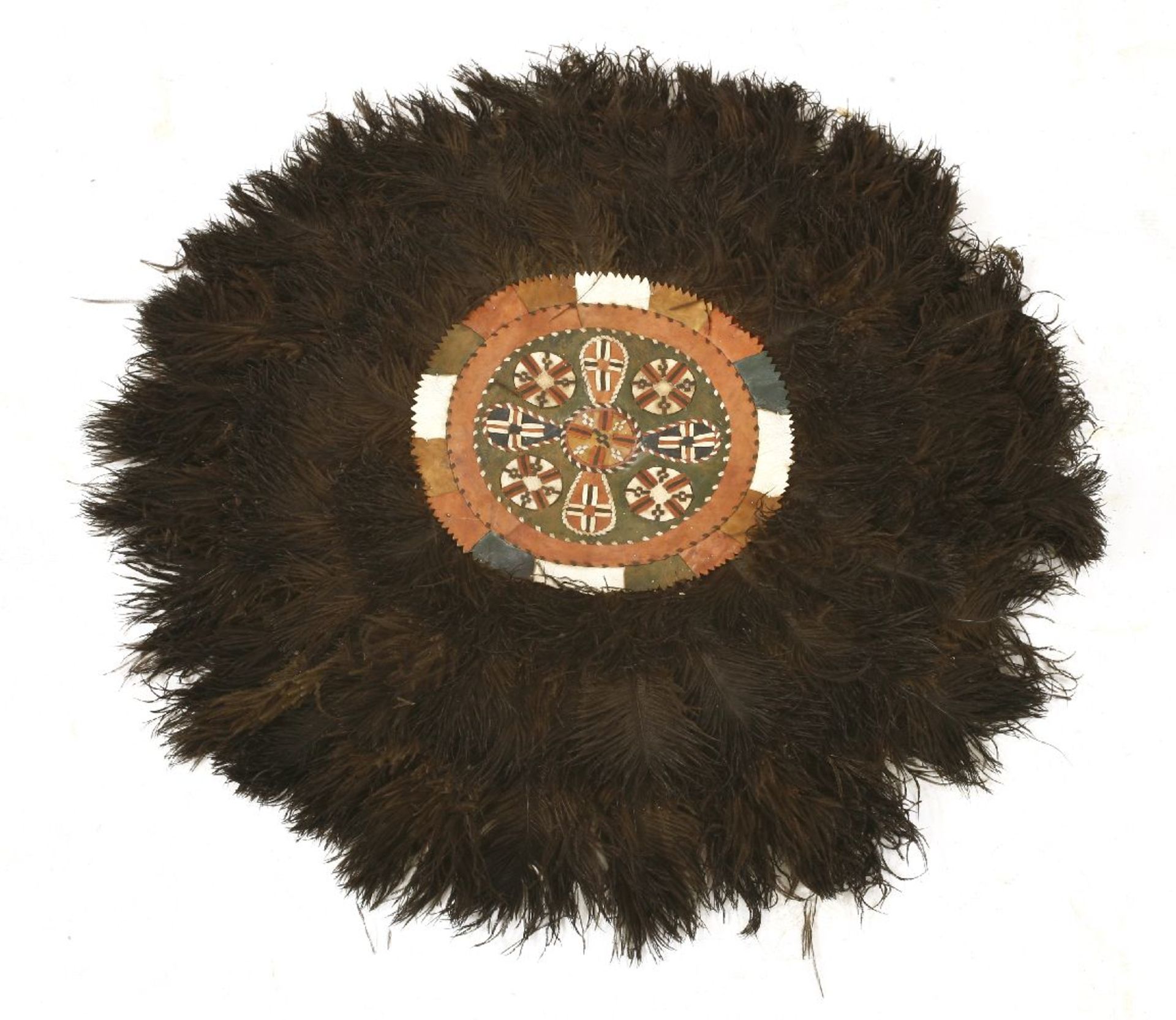 An African ostrich feather and leather panel,70cm diameter